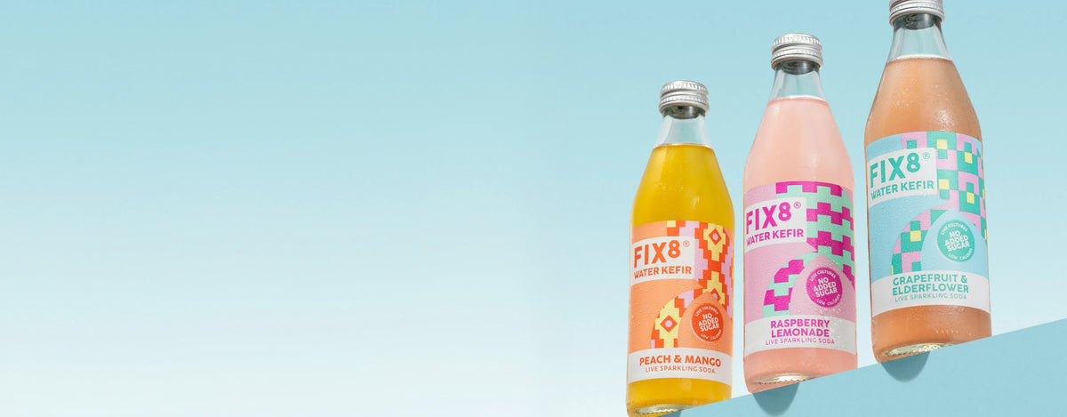 Fix8 Water Kefir bottles on a pale blue background